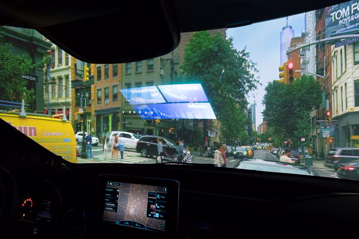 View from inside the Dragon Drive demonstration vehicle showing a four-panel windshield HUD over a city street and a companion display below
